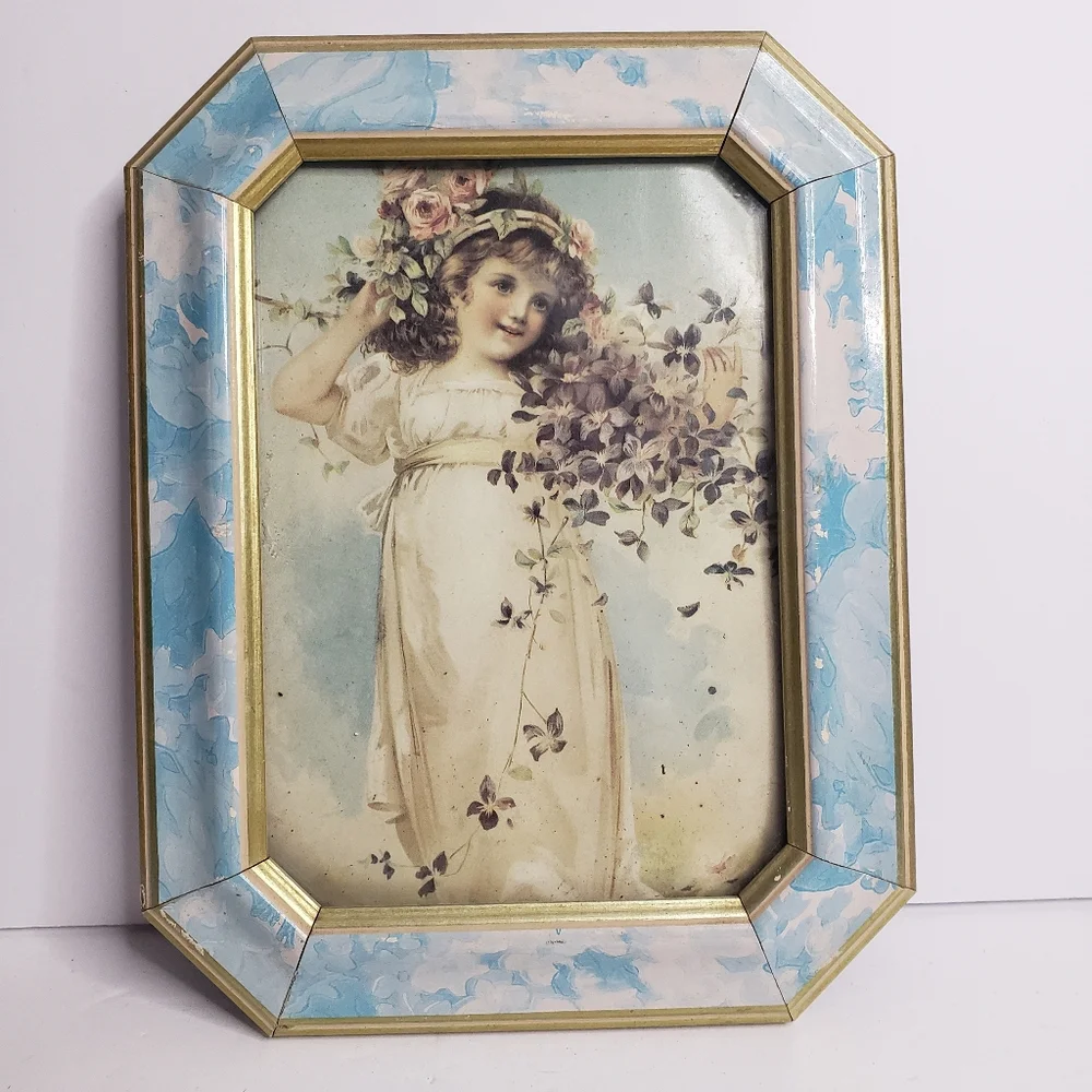 Vintage-style framed print of a young girl adorned with flowers.  228